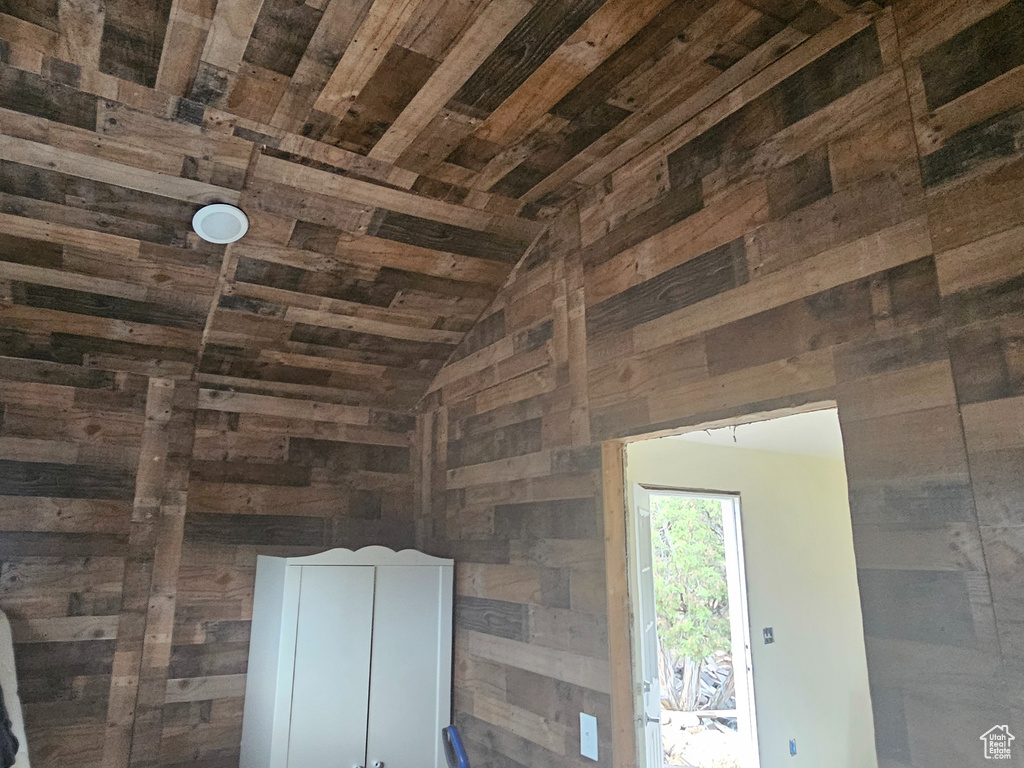 Room details with wood walls and wooden ceiling