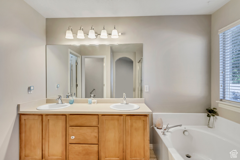 Bathroom featuring a bathing tub and vanity