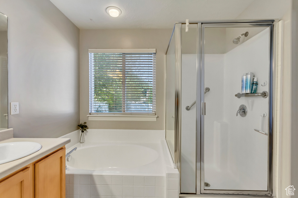 Bathroom with shower with separate bathtub and vanity