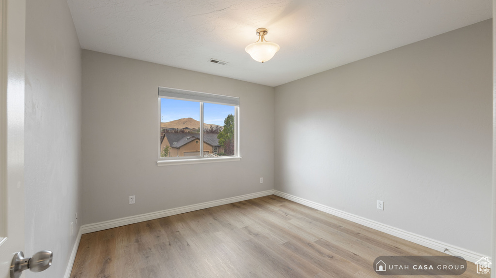 Spare room with light hardwood / wood-style flooring