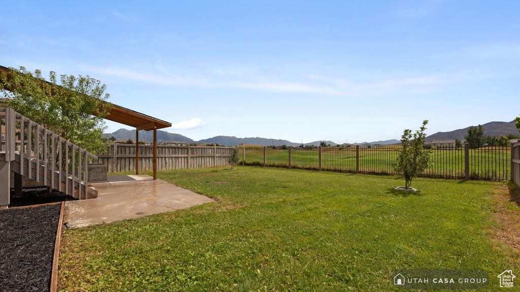 View of yard featuring a mountain view and a patio area