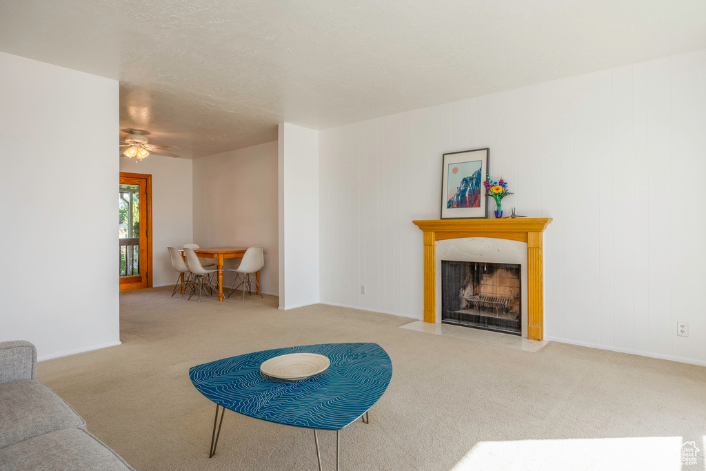 Living room with light colored carpet and ceiling fan