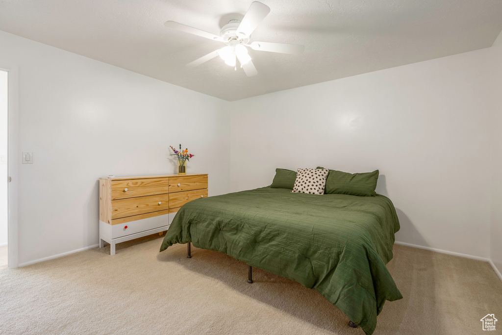 Bedroom featuring ceiling fan and light carpet