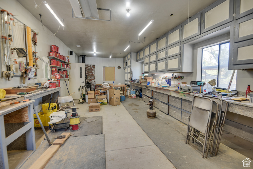 Misc room with a workshop area and concrete floors