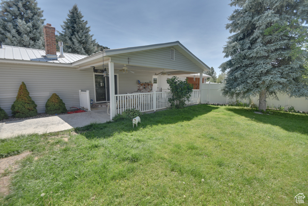 Back of property featuring a yard, ceiling fan, and a patio area