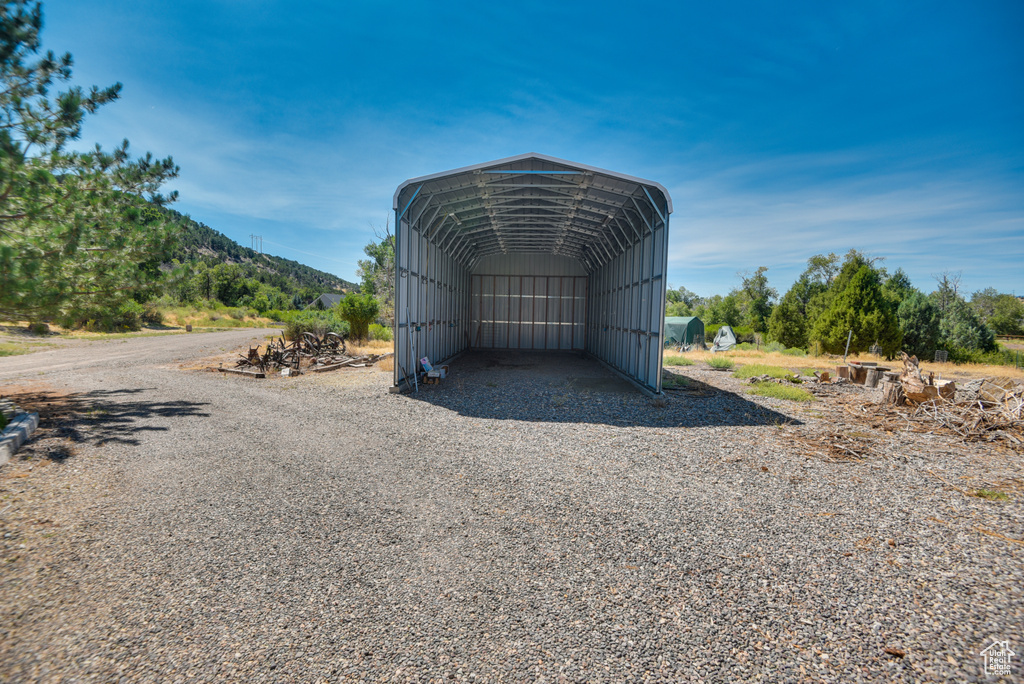 View of outbuilding featuring a carport and a mountain view