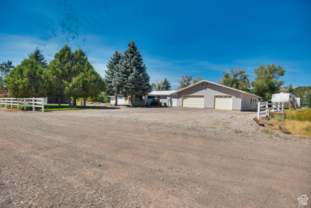 View of property exterior featuring a garage and an outdoor structure