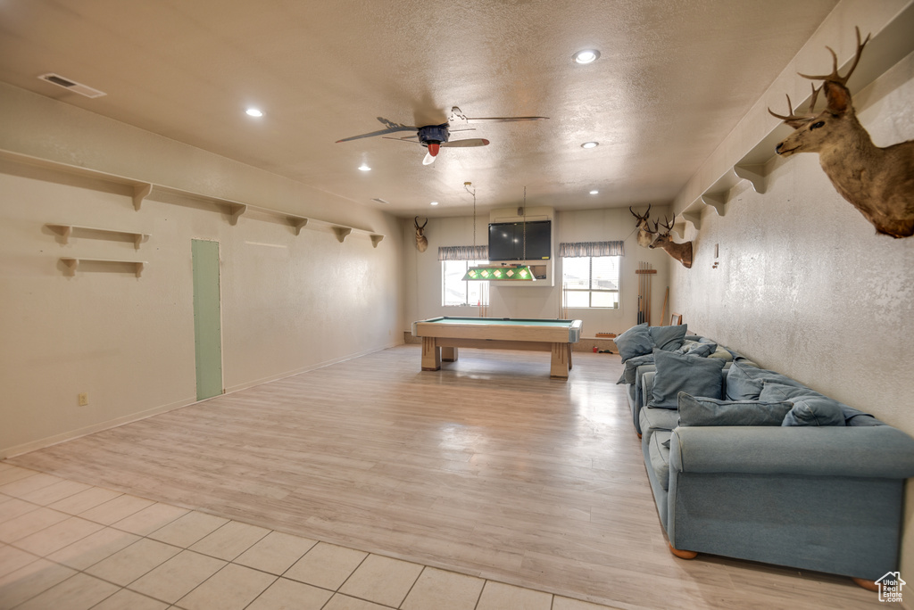 Living room with billiards, ceiling fan, and light hardwood / wood-style floors