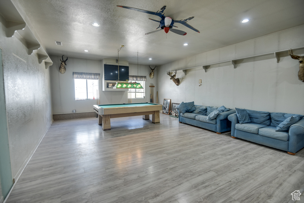Recreation room with billiards, light hardwood / wood-style floors, a textured ceiling, and ceiling fan