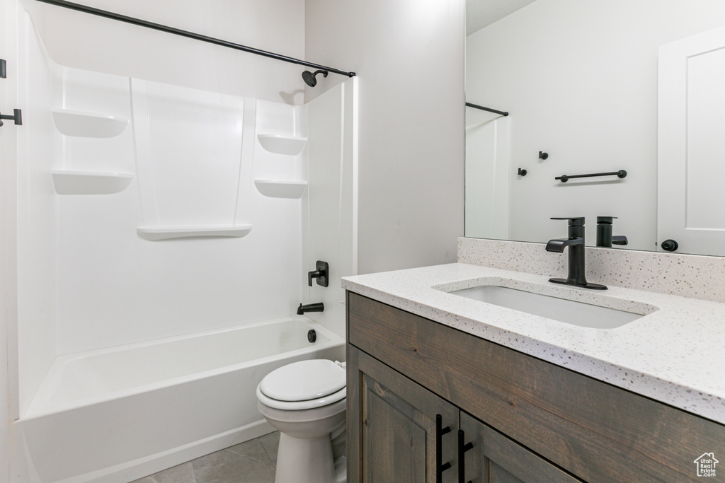 Full bathroom featuring tile patterned floors, shower / tub combination, vanity, and toilet