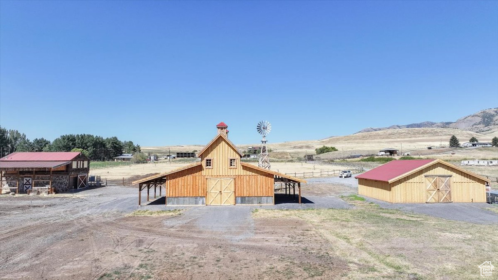 Exterior space with an outdoor structure, a mountain view, and a rural view