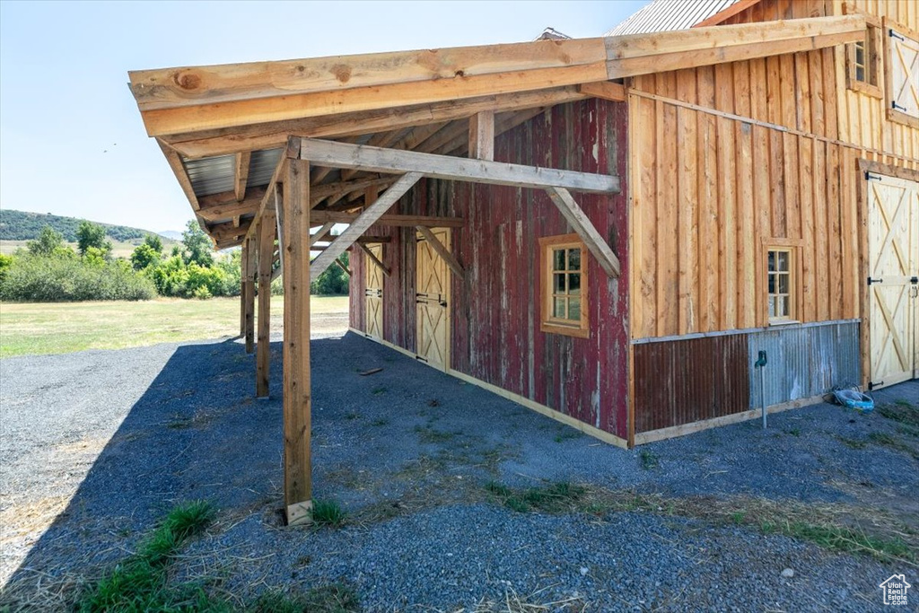 View of side of home featuring an outdoor structure