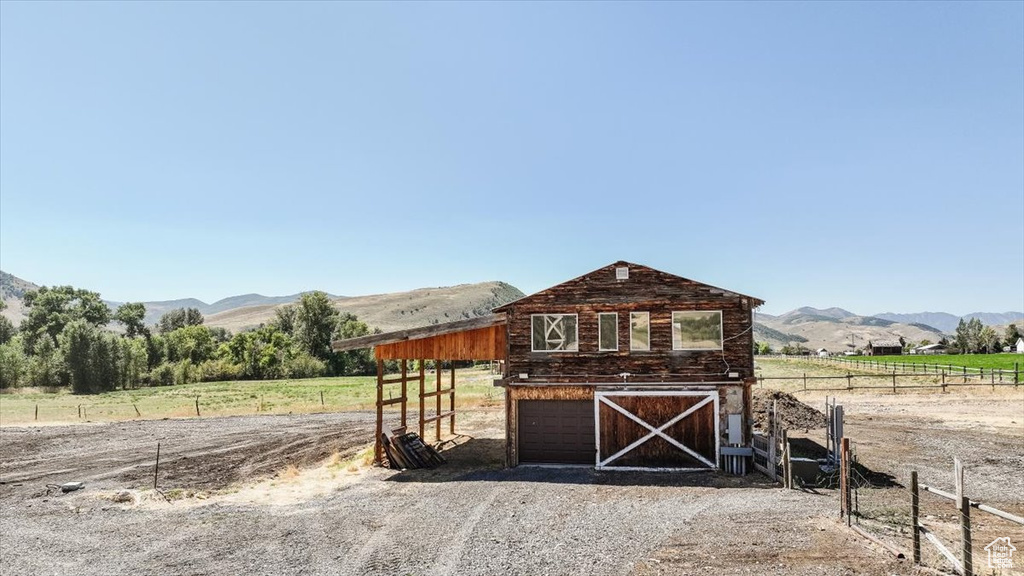 View of outdoor structure featuring a mountain view and a rural view