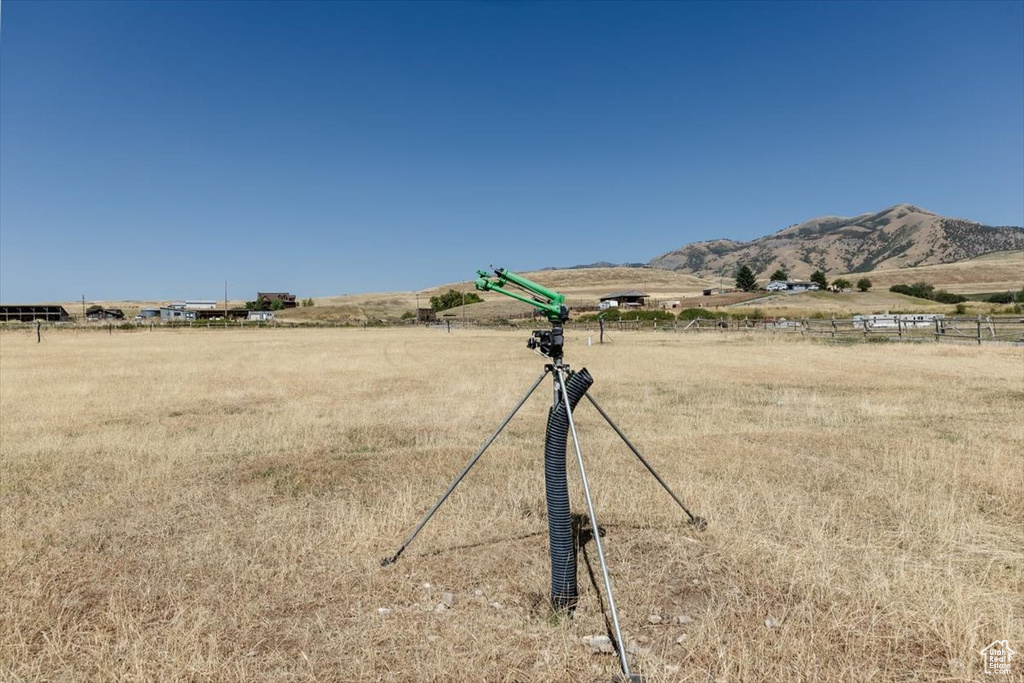 View of yard with a rural view and a mountain view