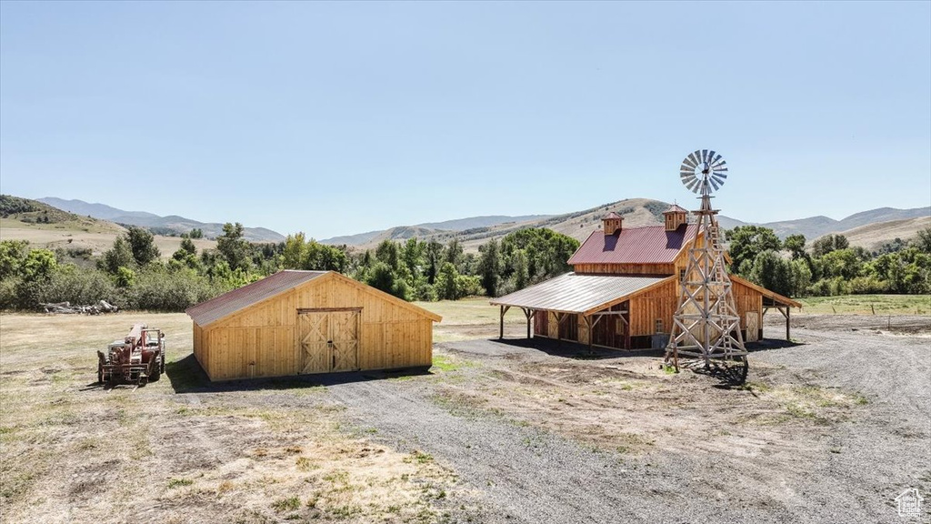 View of yard featuring a rural view, a shed, and a mountain view