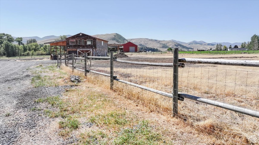 View of yard featuring a rural view and a mountain view