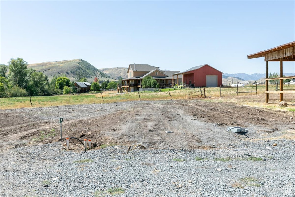 View of yard featuring a rural view and a mountain view