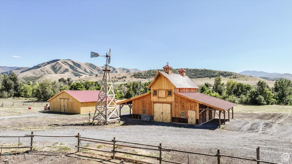 Exterior space with an outbuilding, a mountain view, and a rural view