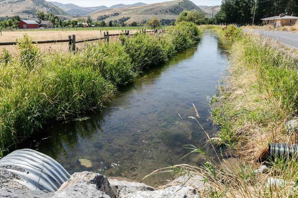 View of water feature featuring a mountain view and a rural view