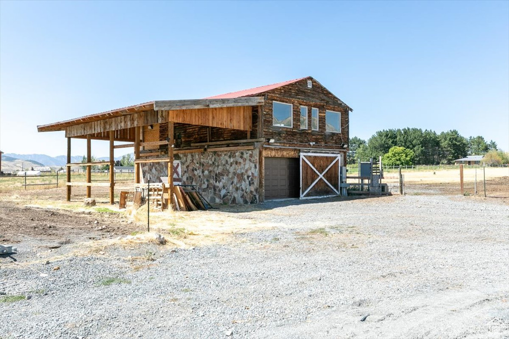 View of outdoor structure with a mountain view and a rural view