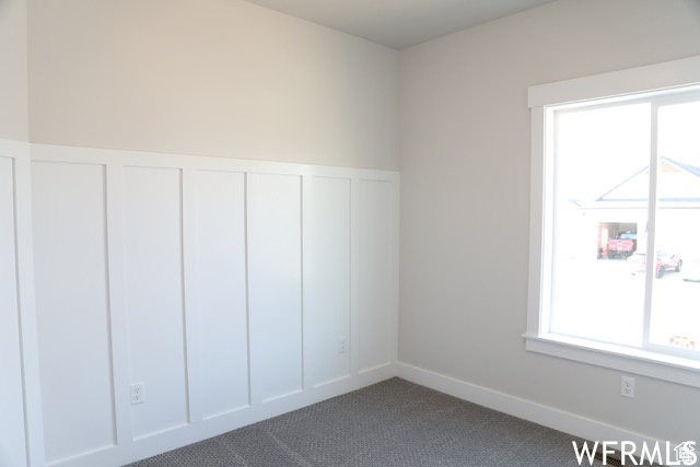 Interior space with a healthy amount of sunlight and carpet flooring