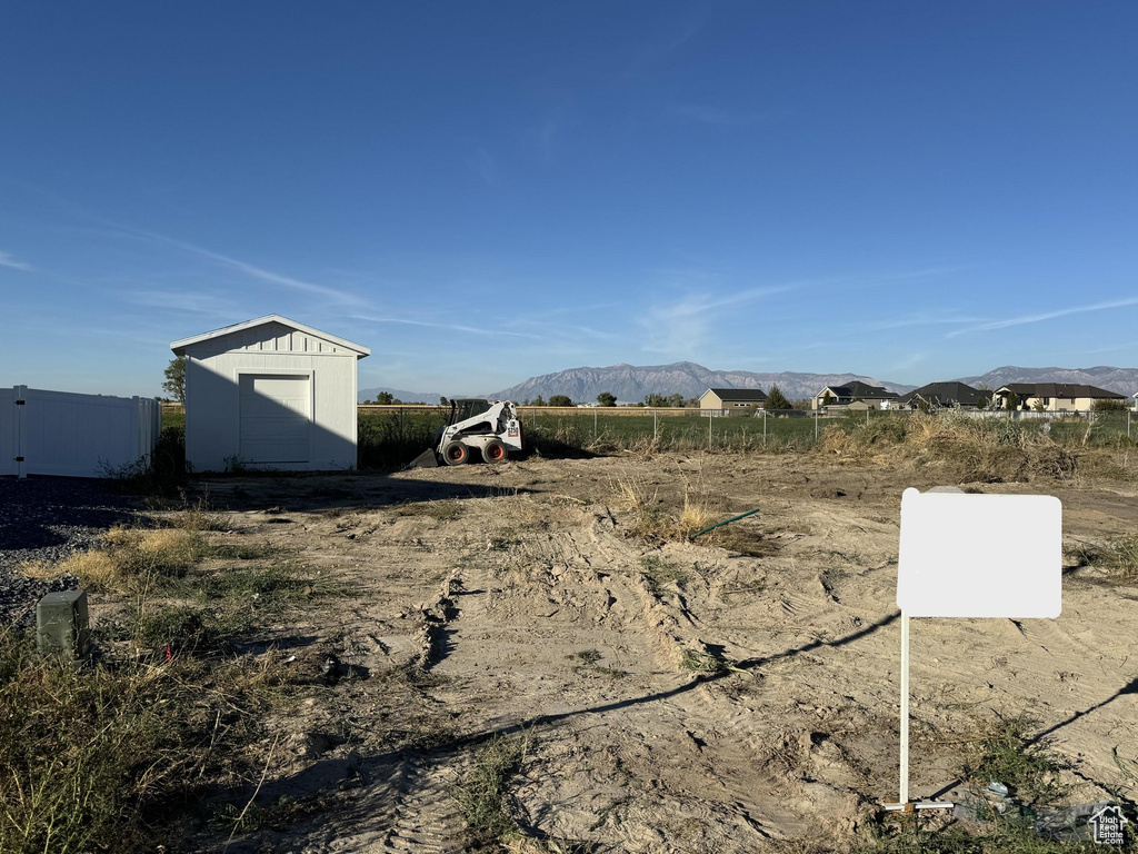 View of yard with a mountain view and a shed