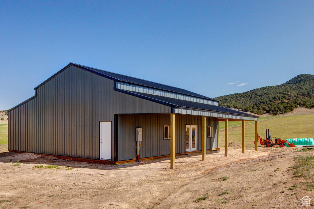 Exterior space featuring a mountain view and an outdoor structure