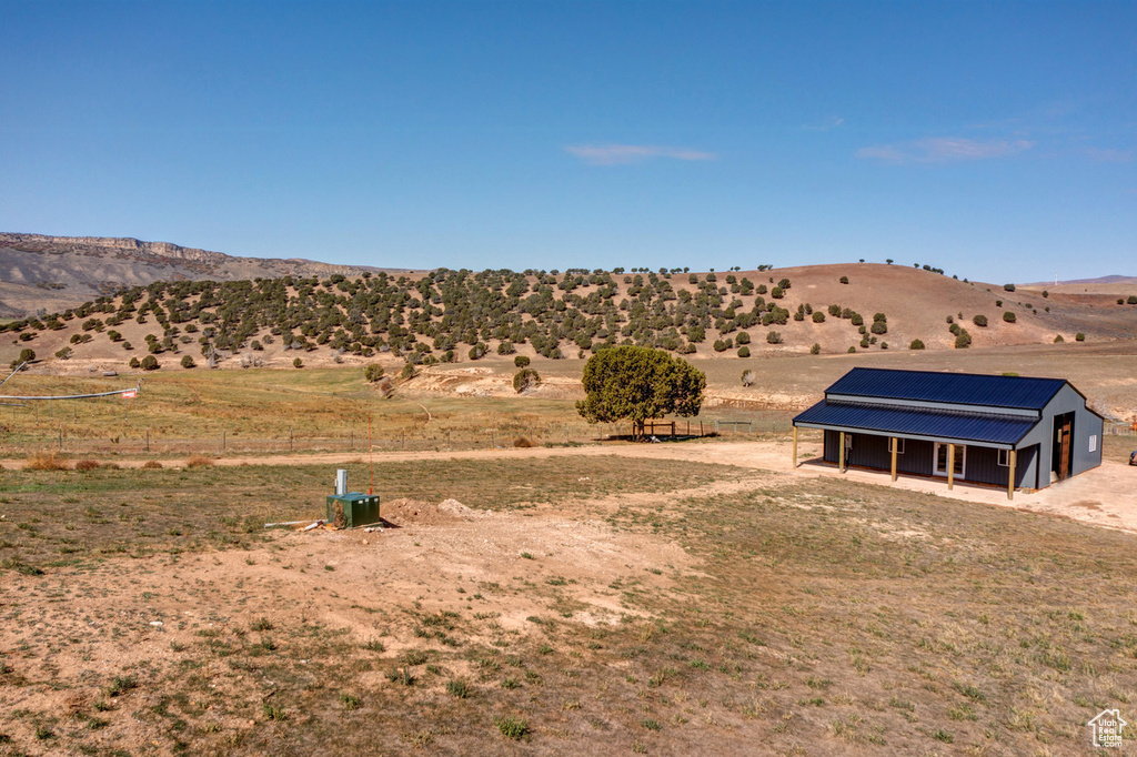Property view of mountains with a rural view