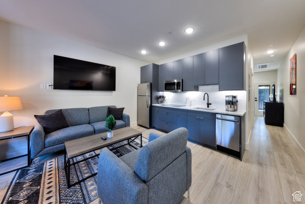 Living room featuring light hardwood / wood-style flooring and sink