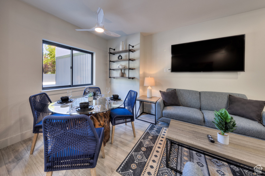 Living room featuring ceiling fan and light hardwood / wood-style flooring