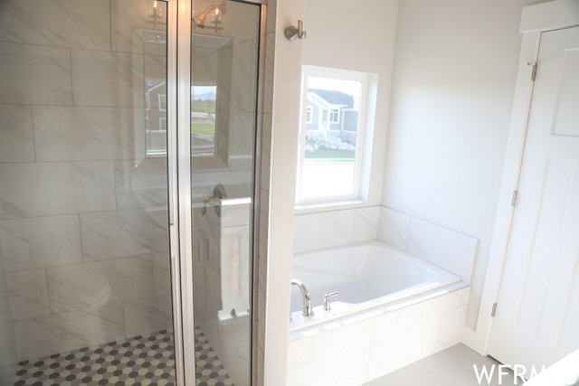 Bathroom featuring separate shower and tub