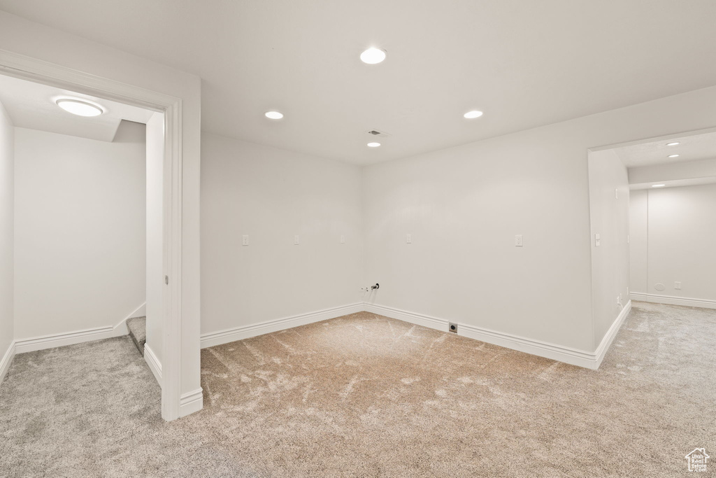 Basement featuring light colored carpet