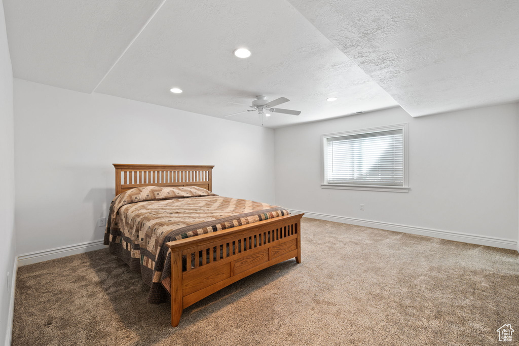 Carpeted bedroom with ceiling fan