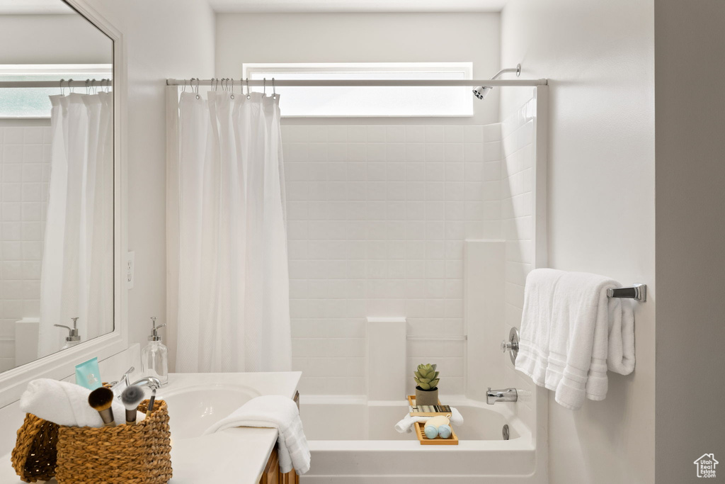 Bathroom featuring shower / tub combo with curtain and vanity