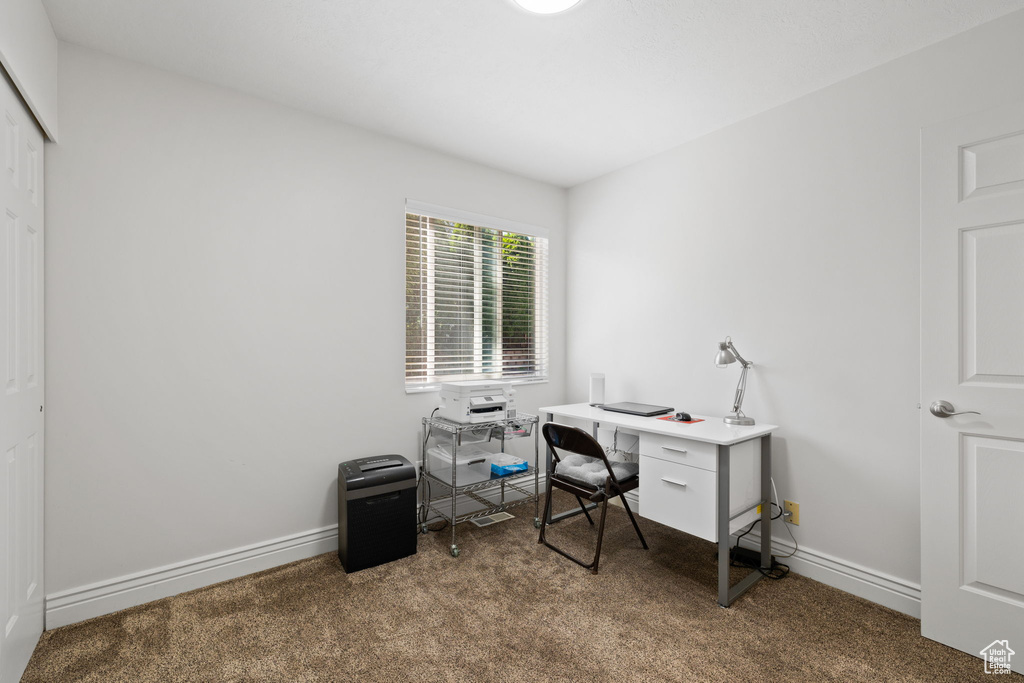 Office featuring dark colored carpet