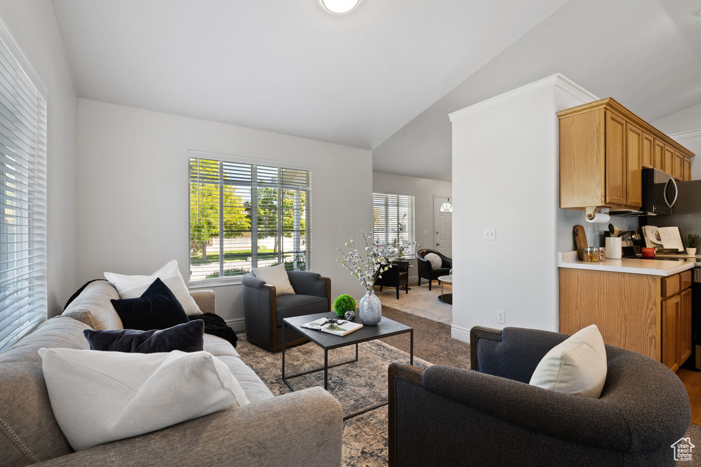 Living room featuring lofted ceiling and light carpet