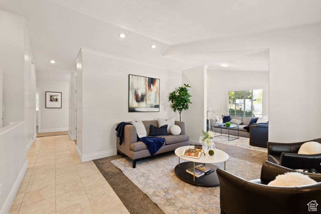 Living room featuring vaulted ceiling and light tile patterned floors