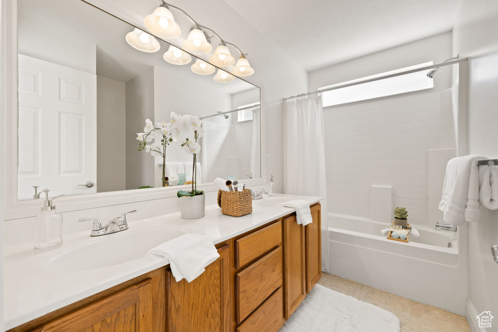 Bathroom featuring vanity, tile patterned floors, and shower / bath combo