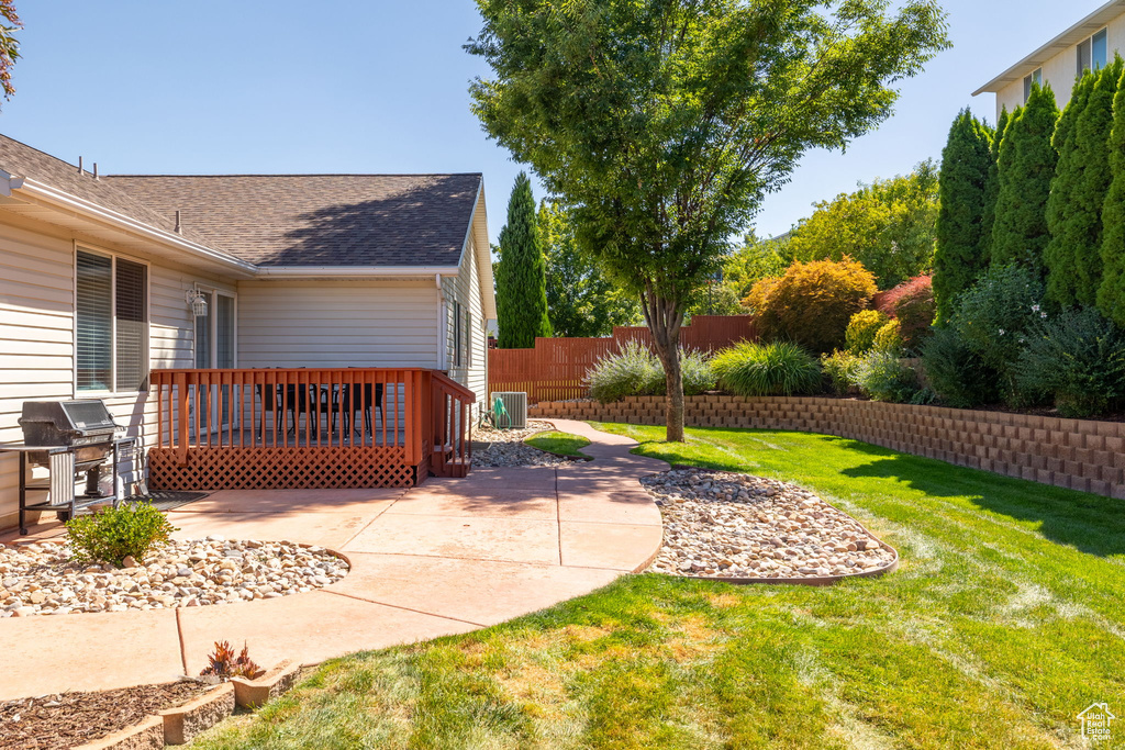 View of yard with a patio area and central AC unit