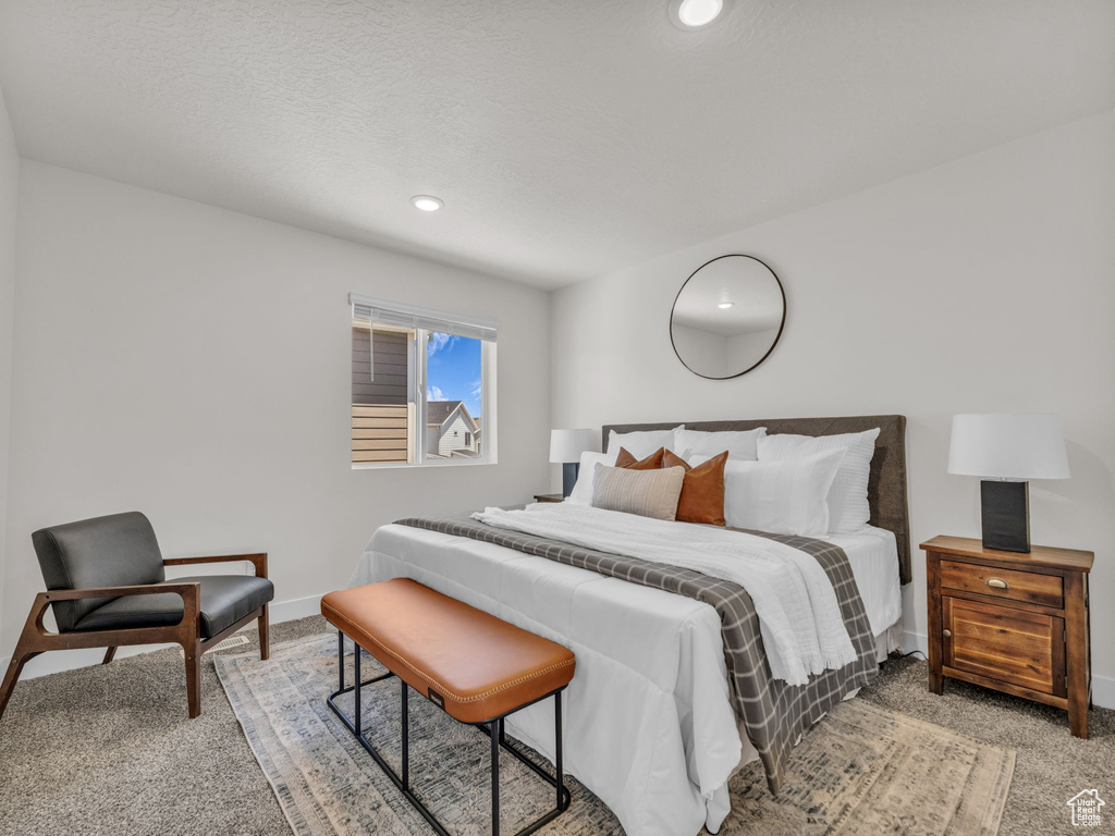 Bedroom featuring light carpet, baseboards, and recessed lighting