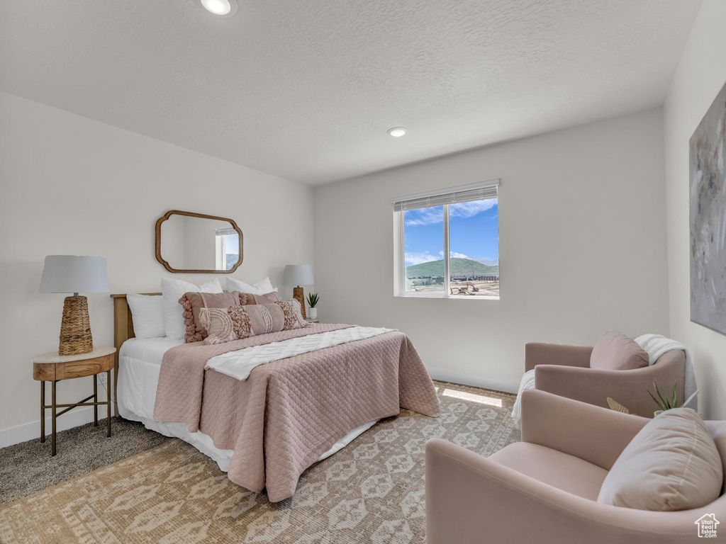 Bedroom featuring recessed lighting, baseboards, and light colored carpet