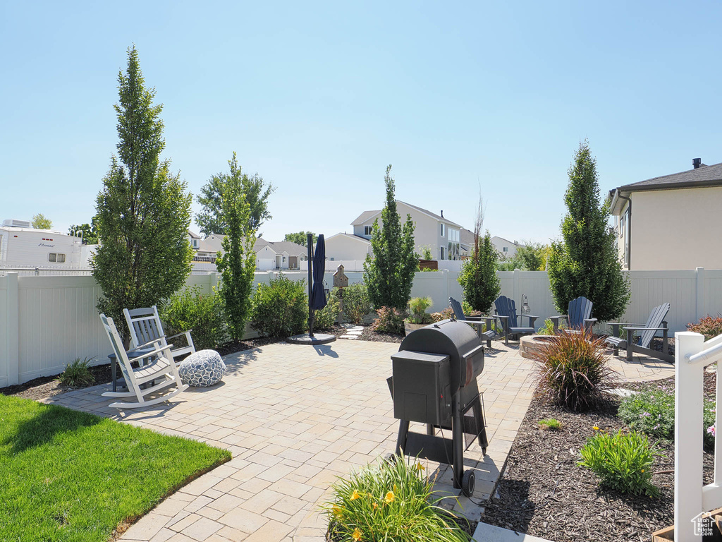 View of patio with a fire pit