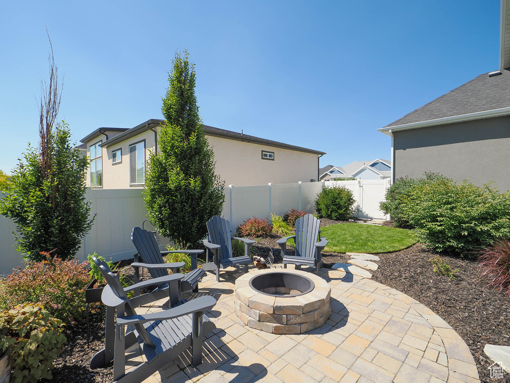 View of patio with a fire pit