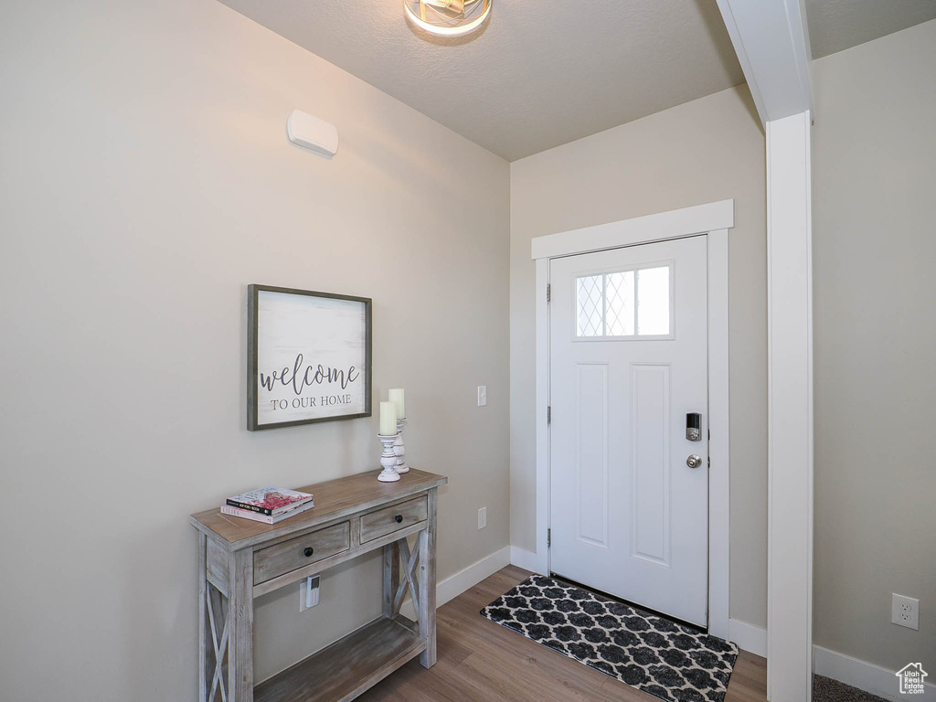 Entrance foyer with hardwood / wood-style floors