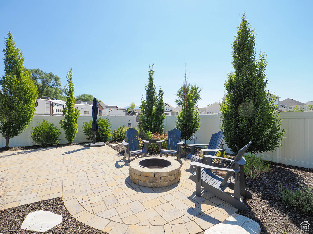 View of patio with a fire pit