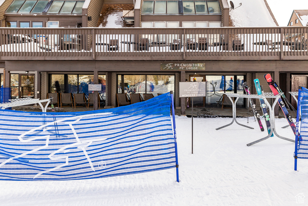 Snow covered patio with a wooden deck