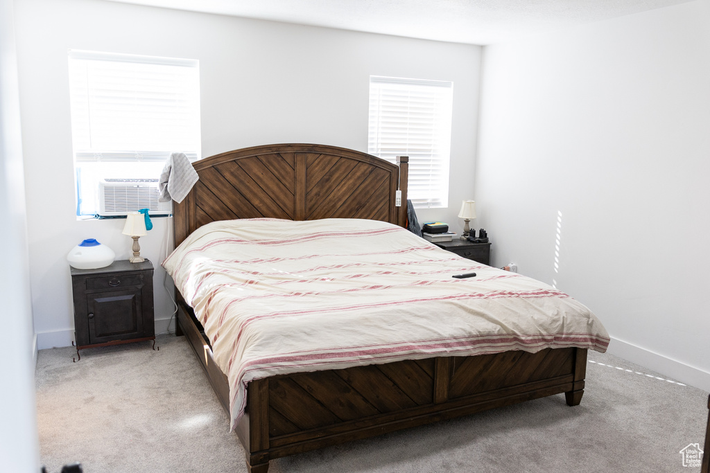 Carpeted bedroom with cooling unit