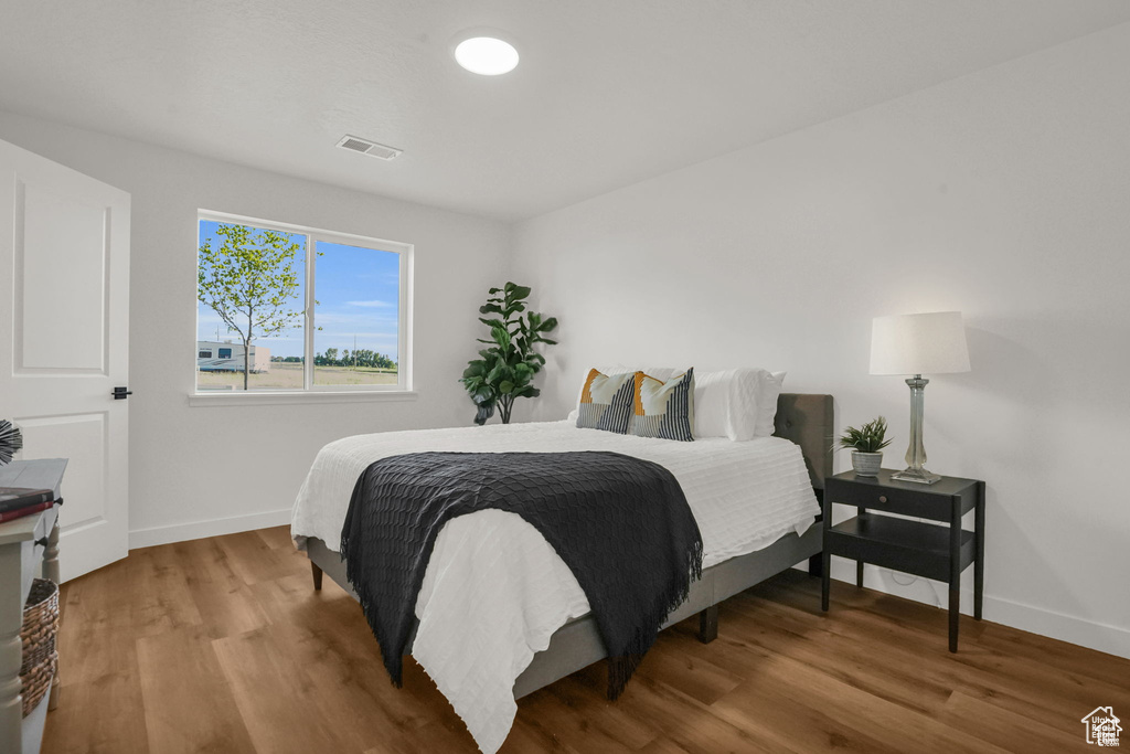 Bedroom with wood-type flooring