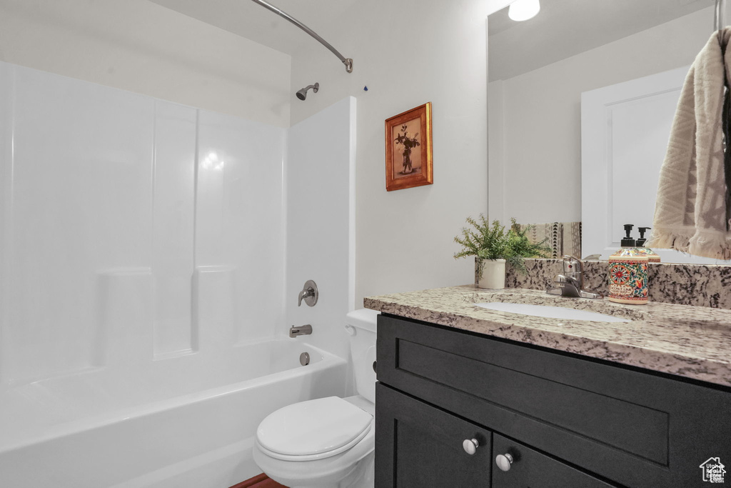 Full bathroom with vanity, toilet, and shower / washtub combination