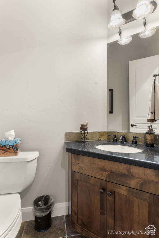 Bathroom featuring vanity, toilet, and tile patterned floors